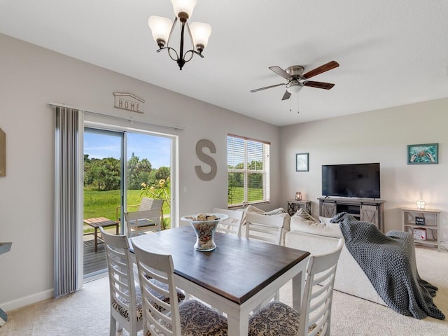 2536 Creekside Dr, Fort Pierce, FL 34981 - dining space with light carpet, a ceiling fan, a chandelier, and baseboards