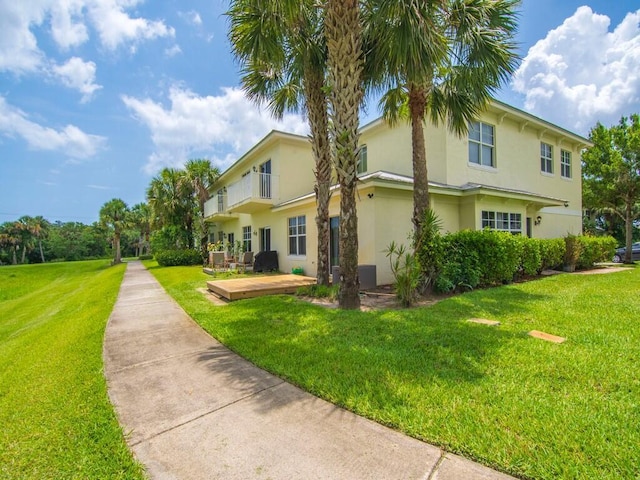 2536 Creekside Dr, Fort Pierce, FL 34981 - view of side of home featuring stucco siding and a lawn
