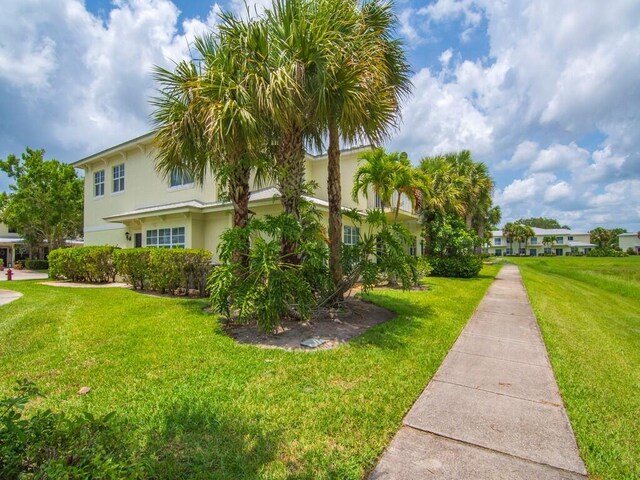 2536 Creekside Dr, Fort Pierce, FL 34981 - view of side of property with a lawn and stucco siding