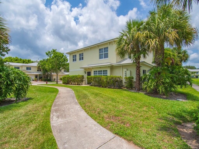 2536 Creekside Dr, Fort Pierce, FL 34981 - view of front of house featuring stucco siding and a front lawn
