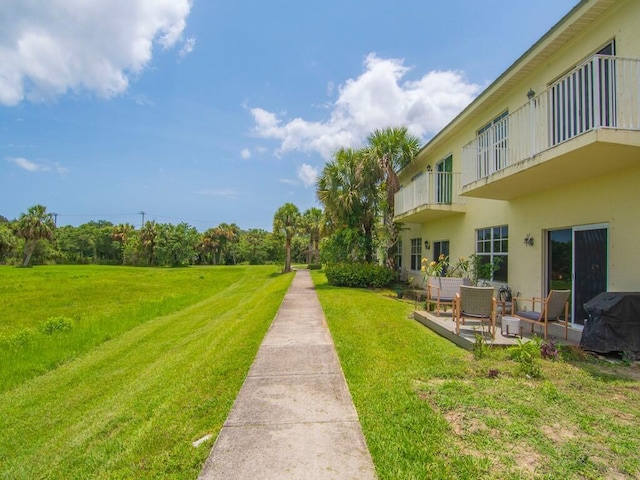 2536 Creekside Dr, Fort Pierce, FL 34981 - view of green lawn with a patio area and a balcony