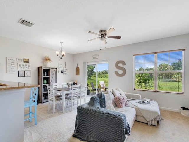 2536 Creekside Dr, Fort Pierce, FL 34981 - living area with light colored carpet, a ceiling fan, a chandelier, and baseboards