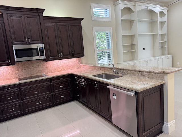 10469 Whitewind Cir, Boynton Beach, FL 33473 - kitchen with stainless steel appliances, a sink, a peninsula, light stone countertops, and light tile patterned flooring