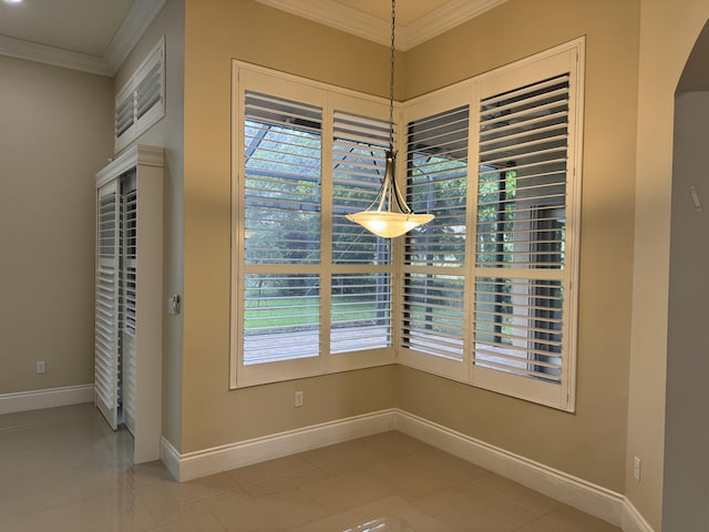 10469 Whitewind Cir, Boynton Beach, FL 33473 - unfurnished dining area featuring crown molding, healthy amount of natural light, arched walkways, baseboards, and light tile patterned flooring