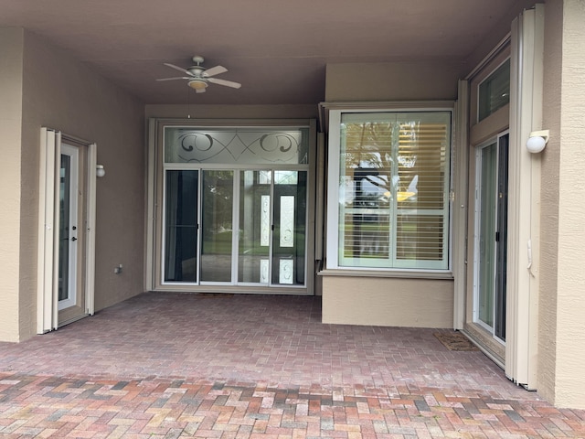 10469 Whitewind Cir, Boynton Beach, FL 33473 - property entrance featuring a ceiling fan and stucco siding