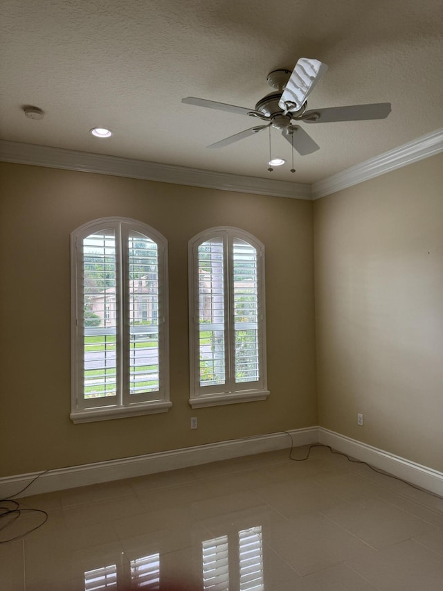 10469 Whitewind Cir, Boynton Beach, FL 33473 - spare room featuring healthy amount of natural light, crown molding, a ceiling fan, light tile patterned flooring, and baseboards