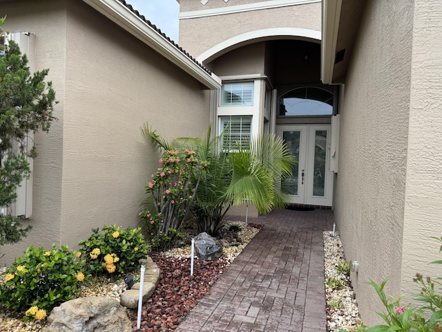 10469 Whitewind Cir, Boynton Beach, FL 33473 - view of exterior entry featuring french doors and stucco siding