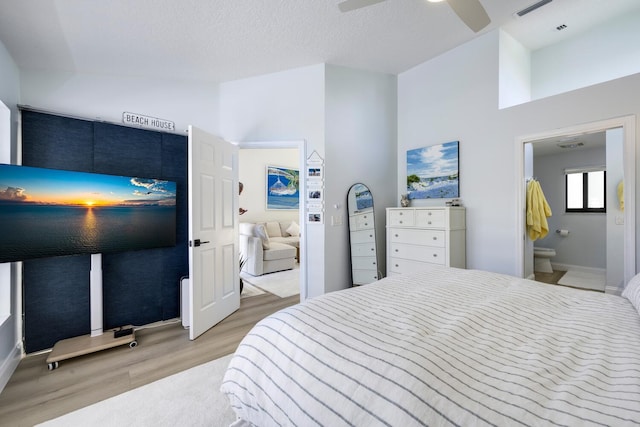 508 Sea Oats Dr Unit A-1, Juno Beach, FL 33408 - bedroom with light wood-style floors, baseboards, ensuite bathroom, and a ceiling fan