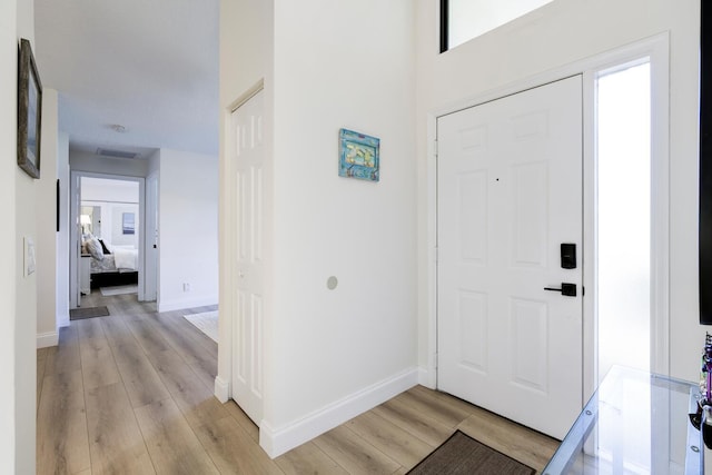 508 Sea Oats Dr Unit A-1, Juno Beach, FL 33408 - foyer entrance with light wood finished floors and baseboards