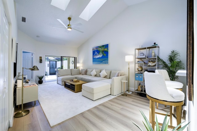508 Sea Oats Dr Unit A-1, Juno Beach, FL 33408 - living room featuring a skylight, light wood-style floors, high vaulted ceiling, and a ceiling fan