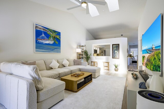 508 Sea Oats Dr Unit A-1, Juno Beach, FL 33408 - living room with lofted ceiling, a skylight, and a ceiling fan