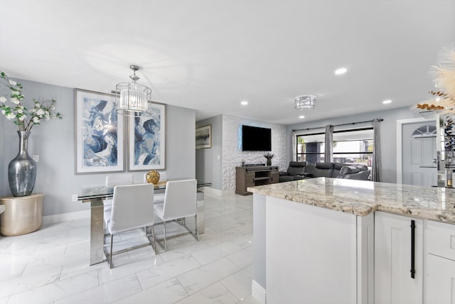 4501 N Australian Ave, West Palm Beach, FL 33407 - kitchen featuring light marble finish flooring, light stone counters, recessed lighting, white cabinetry, and baseboards