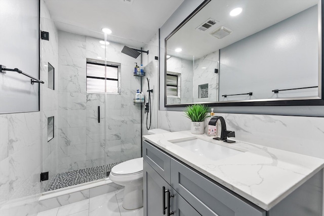 4501 N Australian Ave, West Palm Beach, FL 33407 - full bath featuring marble look tiles, vanity, a marble finish shower, toilet, and recessed lighting