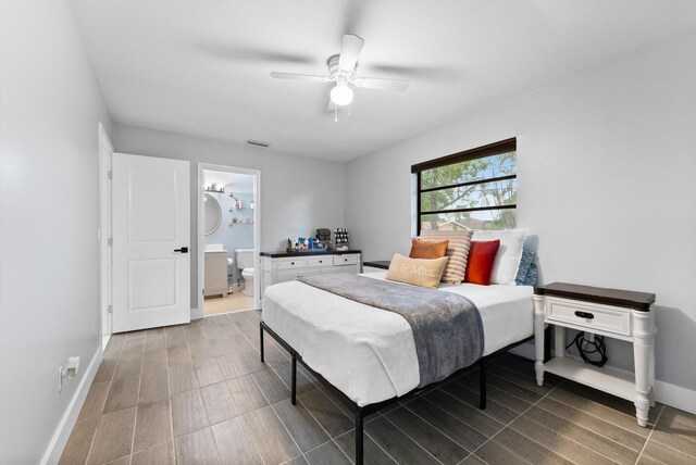 4501 N Australian Ave, West Palm Beach, FL 33407 - bedroom with baseboards, ceiling fan, ensuite bath, and wood finished floors