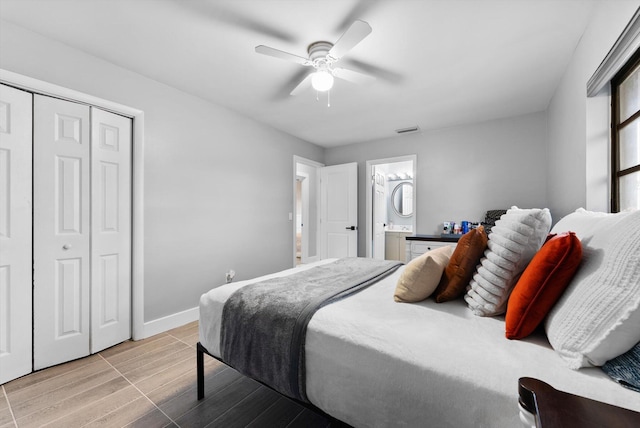 4501 N Australian Ave, West Palm Beach, FL 33407 - bedroom with wood finished floors, baseboards, a ceiling fan, a closet, and ensuite bathroom