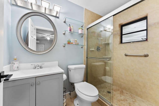 4501 N Australian Ave, West Palm Beach, FL 33407 - bathroom with a tile shower, vanity, toilet, and ceiling fan