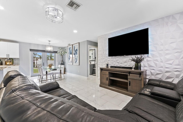 4501 N Australian Ave, West Palm Beach, FL 33407 - living area with light marble finish flooring, recessed lighting, baseboards, and an accent wall