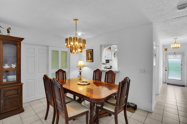 14775 Wildflower Ln, Delray Beach, FL 33446 - dining room featuring a chandelier, a textured ceiling, and light tile patterned flooring