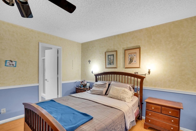 14775 Wildflower Ln, Delray Beach, FL 33446 - bedroom with light wood finished floors, a textured ceiling, and a ceiling fan