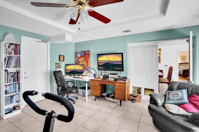 14775 Wildflower Ln, Delray Beach, FL 33446 - tiled office space with a textured ceiling, a ceiling fan, and a tray ceiling