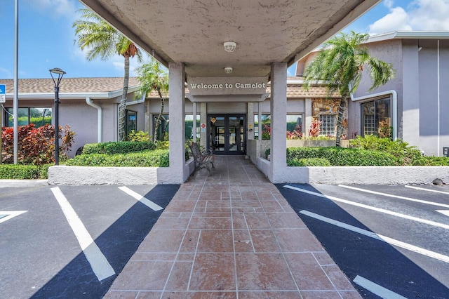 14775 Wildflower Ln, Delray Beach, FL 33446 - view of exterior entry with french doors and stucco siding