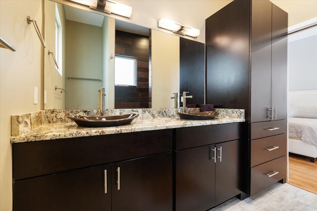 10851 S Ocean Dr Unit 84, Jensen Beach, FL 34957 - ensuite bathroom with double vanity and wood finished floors