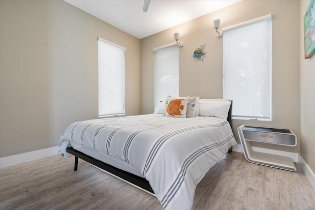10851 S Ocean Dr Unit 84, Jensen Beach, FL 34957 - bedroom featuring wood finished floors, baseboards, and ceiling fan