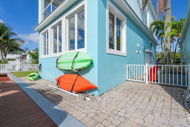 10851 S Ocean Dr Unit 84, Jensen Beach, FL 34957 - view of side of home with stucco siding and a patio