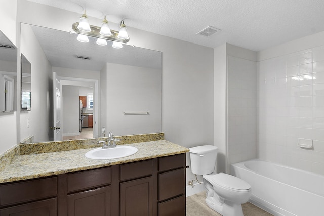 1595 SE Pomeroy St, Stuart, FL 34997 - bathroom with toilet, vanity, a textured ceiling, tile patterned flooring, and shower / bath combination