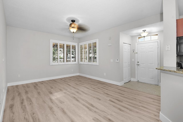 1595 SE Pomeroy St, Stuart, FL 34997 - interior space with light wood-style floors, ceiling fan, plenty of natural light, and baseboards