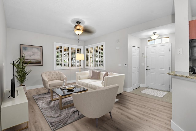 1595 SE Pomeroy St, Stuart, FL 34997 - living room featuring light wood-style floors, ceiling fan, and baseboards