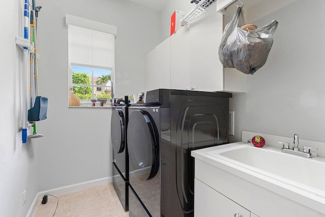 102 Andalusia Way, Palm Beach Gardens, FL 33418 - laundry room featuring washing machine and clothes dryer, cabinet space, baseboards, and light tile patterned floors