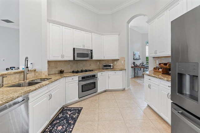 102 Andalusia Way, Palm Beach Gardens, FL 33418 - kitchen with stainless steel appliances, a sink, crown molding, backsplash, and white cabinetry