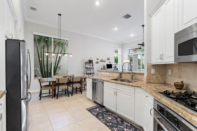 102 Andalusia Way, Palm Beach Gardens, FL 33418 - kitchen featuring appliances with stainless steel finishes, a sink, backsplash, white cabinets, and ornamental molding