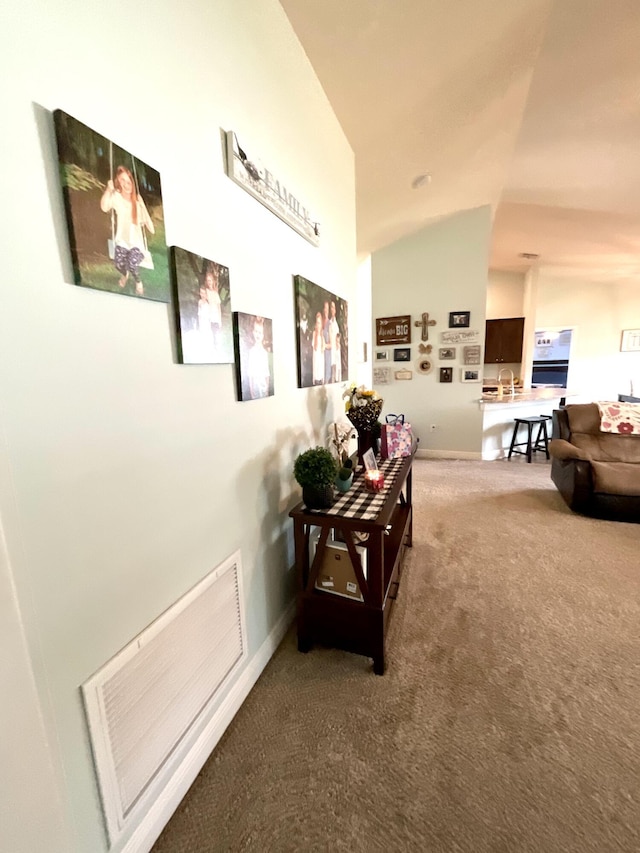 1206 SW Bargello Ave SW, Port Saint Lucie, FL 34953 - corridor with carpet floors, baseboards, and lofted ceiling