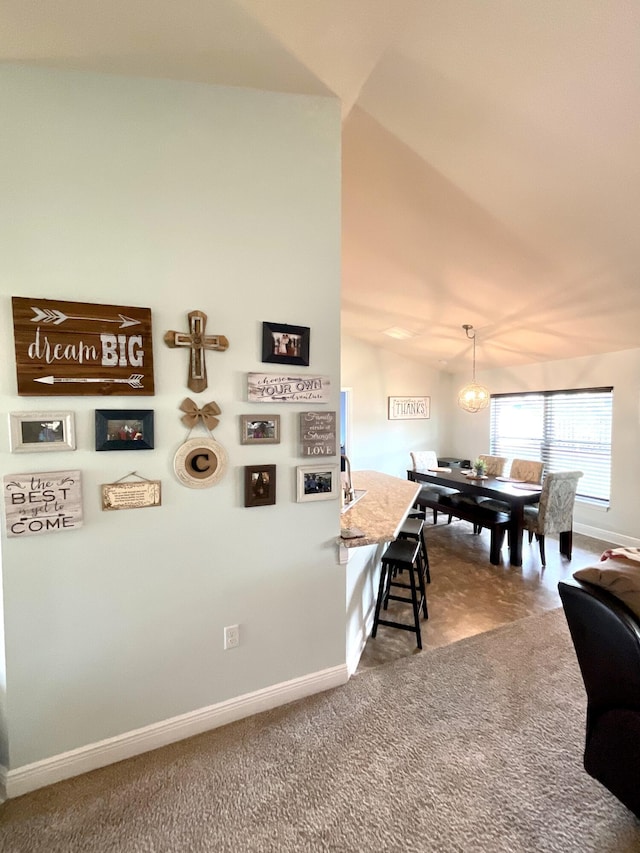 1206 SW Bargello Ave SW, Port Saint Lucie, FL 34953 - dining space featuring baseboards, carpet floors, and vaulted ceiling