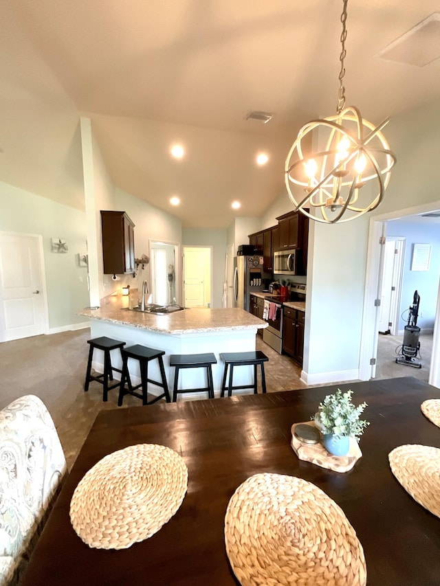 1206 SW Bargello Ave SW, Port Saint Lucie, FL 34953 - dining room featuring a chandelier, vaulted ceiling, baseboards, and recessed lighting