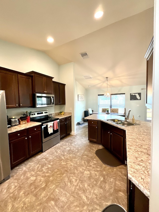 1206 SW Bargello Ave SW, Port Saint Lucie, FL 34953 - kitchen with stainless steel appliances, a sink, vaulted ceiling, dark brown cabinetry, and light countertops