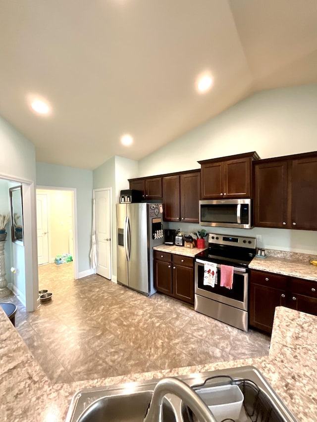 1206 SW Bargello Ave SW, Port Saint Lucie, FL 34953 - kitchen with stainless steel appliances, vaulted ceiling, dark brown cabinetry, light countertops, and recessed lighting
