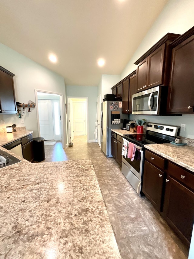 1206 SW Bargello Ave SW, Port Saint Lucie, FL 34953 - kitchen with appliances with stainless steel finishes, dark brown cabinetry, vaulted ceiling, and recessed lighting