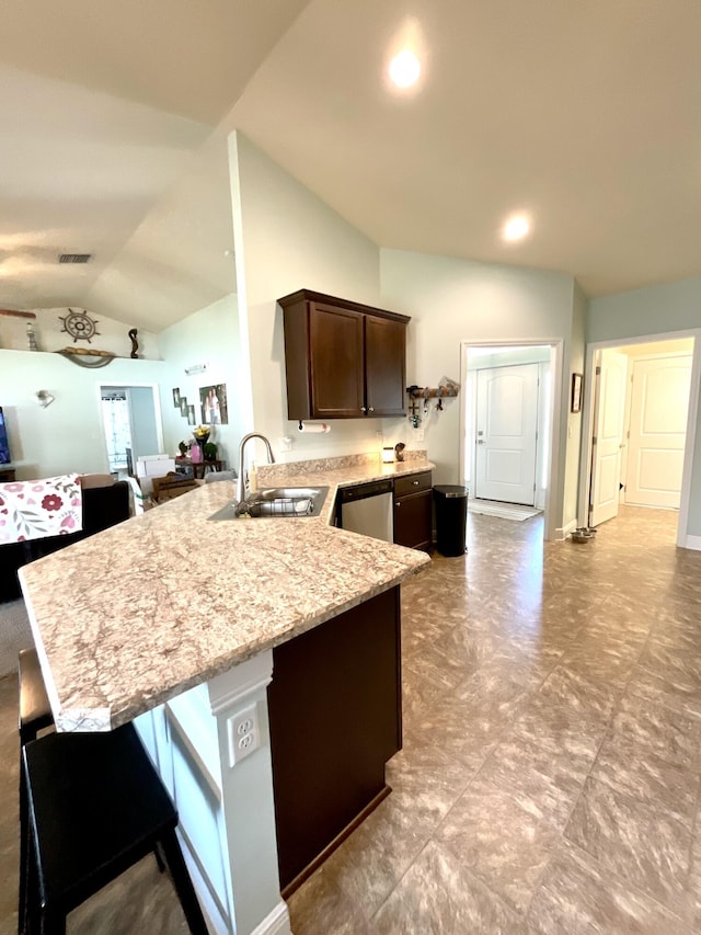 1206 SW Bargello Ave SW, Port Saint Lucie, FL 34953 - kitchen featuring a sink, dark brown cabinets, a peninsula, stainless steel dishwasher, and lofted ceiling