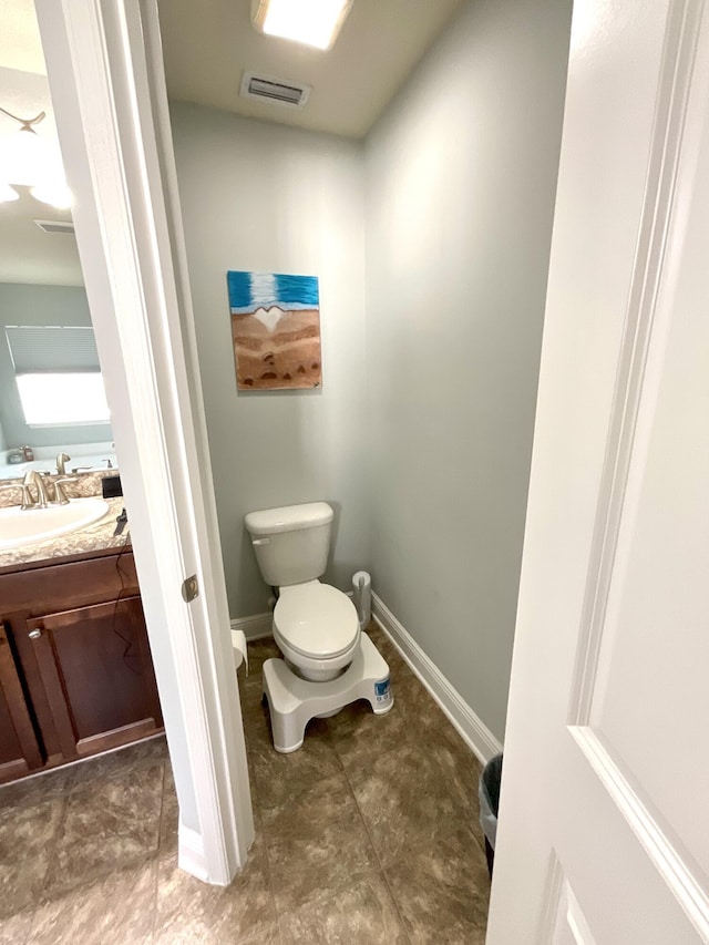 1206 SW Bargello Ave SW, Port Saint Lucie, FL 34953 - half bath featuring toilet, vanity, and baseboards