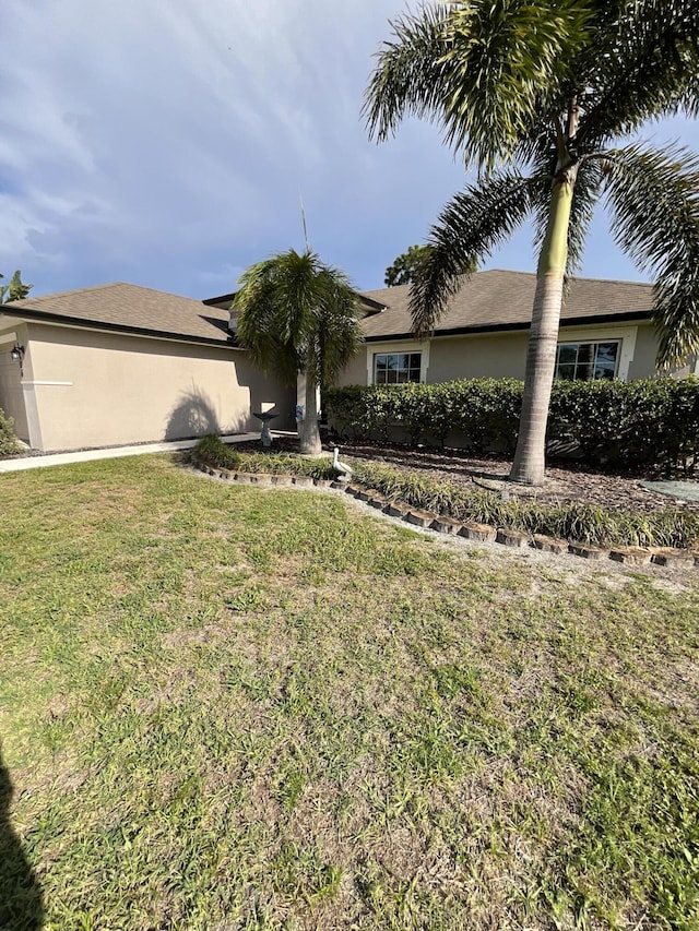 1206 SW Bargello Ave SW, Port Saint Lucie, FL 34953 - view of front of property featuring a front yard and stucco siding