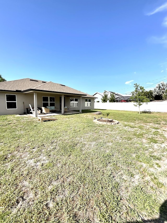 1206 SW Bargello Ave SW, Port Saint Lucie, FL 34953 - rear view of house with an outdoor fire pit, a patio area, and stucco siding