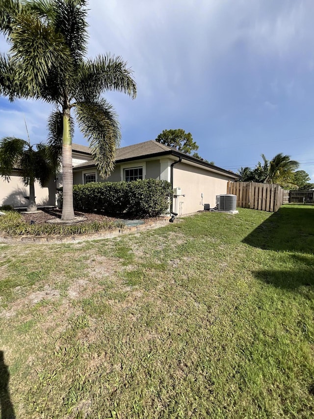 1206 SW Bargello Ave SW, Port Saint Lucie, FL 34953 - view of home's exterior featuring cooling unit and stucco siding
