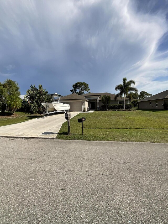 1206 SW Bargello Ave SW, Port Saint Lucie, FL 34953 - view of front of property with driveway, an attached garage, and a front lawn