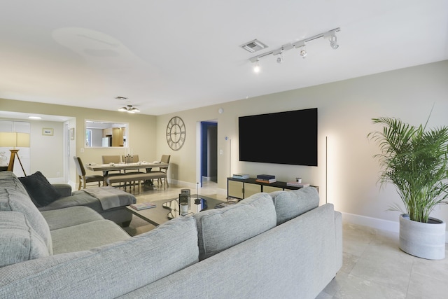 1700 Presidential Way Unit 201, West Palm Beach, FL 33401 - living room featuring baseboards and rail lighting