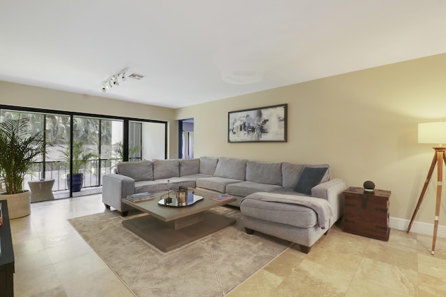 1700 Presidential Way Unit 201, West Palm Beach, FL 33401 - living room featuring rail lighting and baseboards