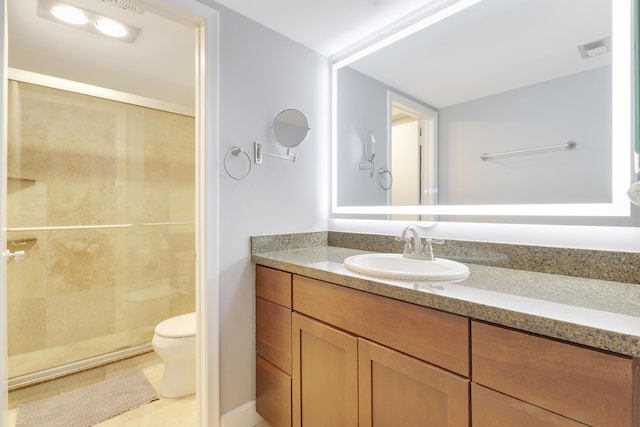 1700 Presidential Way Unit 201, West Palm Beach, FL 33401 - bathroom featuring toilet, vanity, and a stall shower