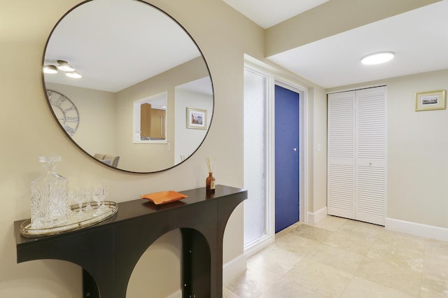 1700 Presidential Way Unit 201, West Palm Beach, FL 33401 - foyer with baseboards and tile patterned flooring